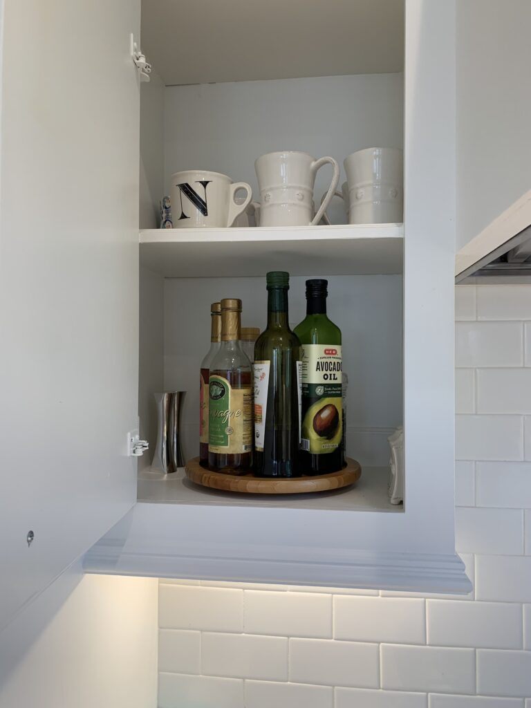 small kitchen cabinet with lazy susan and mugs