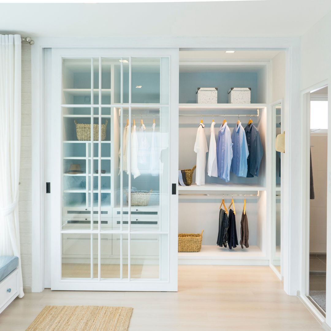 Well organized closet with hanging clothes and baskets