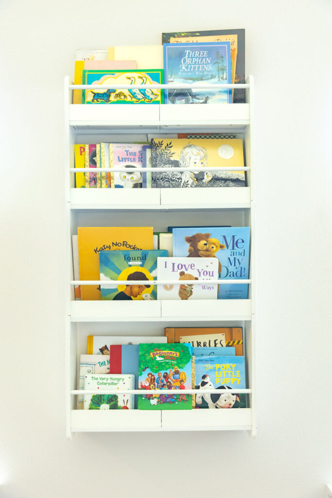 Organized playroom with labeled bins and open floor space for kids’ activities.