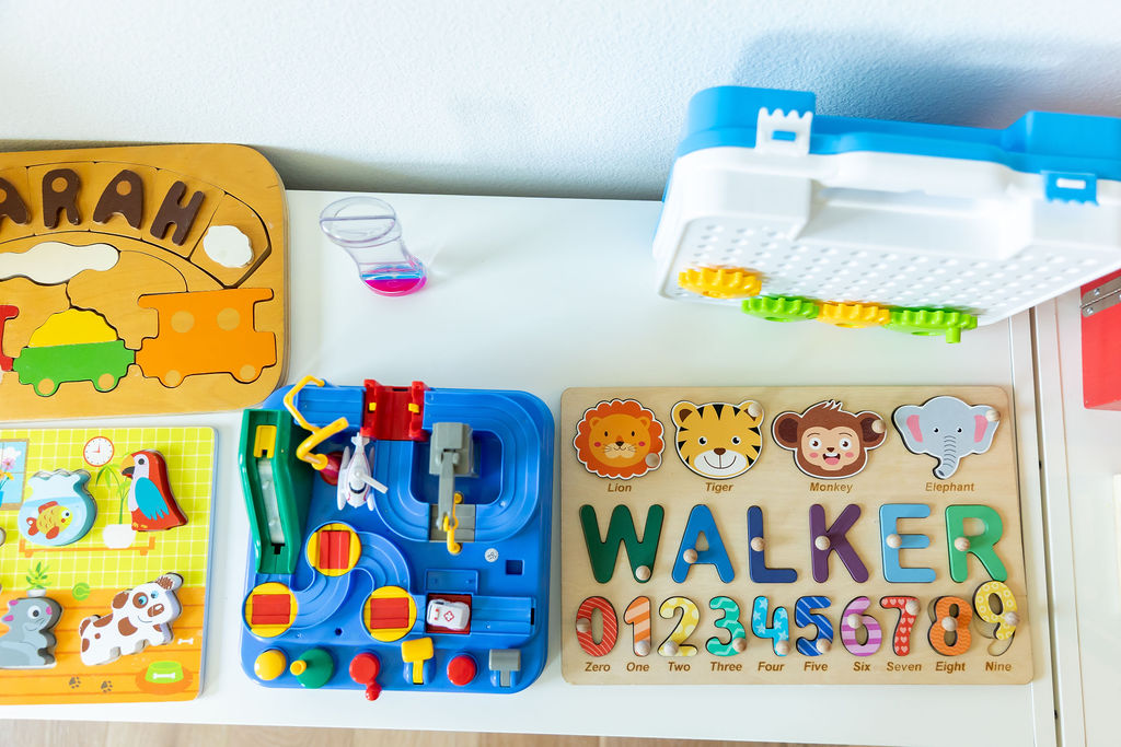 Organized playroom with labeled bins and open floor space for kids’ activities.